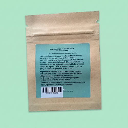 A kraft paper stand-up pouch with a teal product information label on the back, photographed against a solid mint green background.