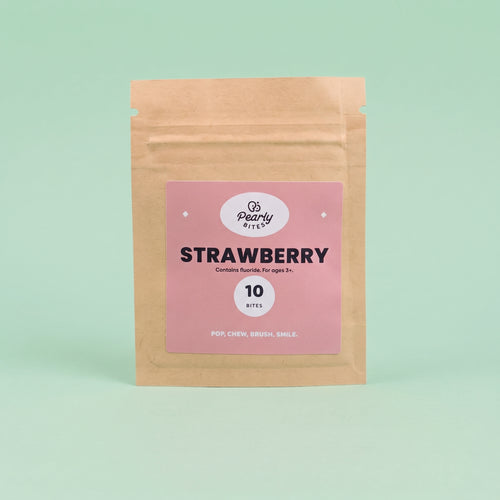 A kraft paper stand-up pouch with a pink label reading 'Pearly bites Strawberry' and '10 notes' on a light mint green background.