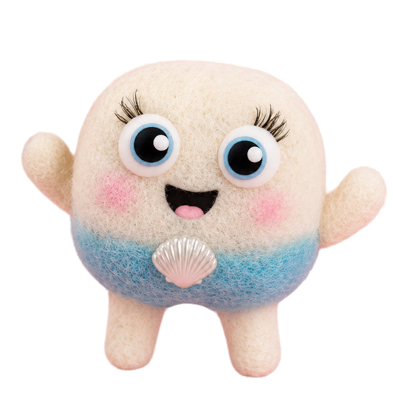 A cute, round felt plush toy with a beige body, blue gradient lower half, pink cheeks, and a silver seashell on its chest
